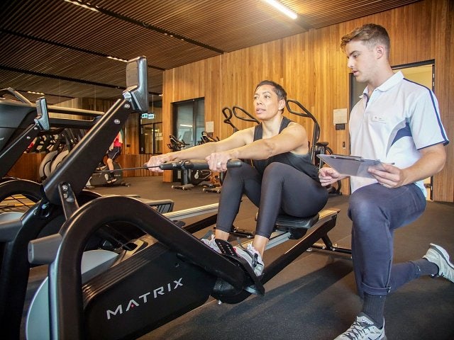 Personal trainer and a female client on the gym floor at Gunyama Park