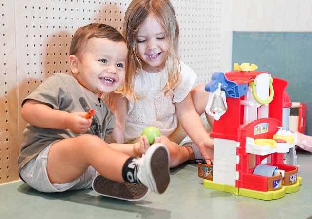 Young children smiling and playing in the creche at Gunyama Park Aquatic and Recreation Centre