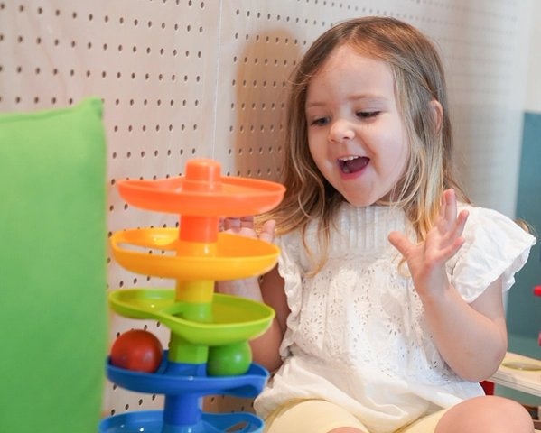 Happy child playing with toys in the Gunyama Park Creche