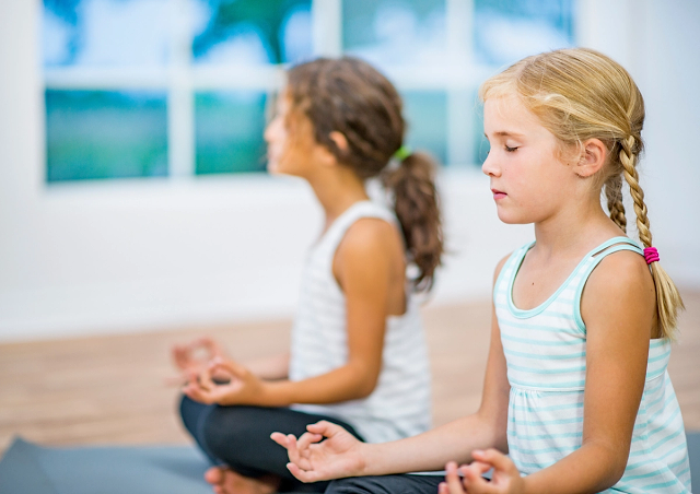 Kids participating in a yoga class