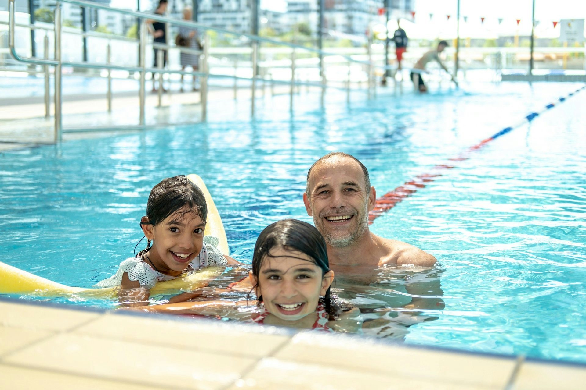 Male and two kids in the pool at Gunyama Park Aquatic and Recreation Centre | City of Sydney Leisure