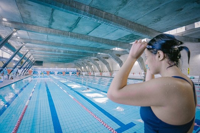 Female about to dive into the 50m pool at Cook+Phillip Park Pool