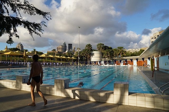 Person walking by Prince Alfred Park Pool