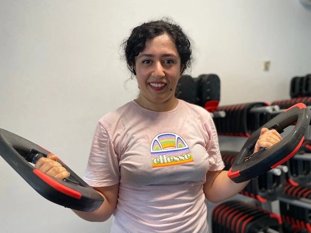 Maryam, a 360 member at Ian Thorpe Aquatic Centre, performs bicep curl using Les Mills smart weights