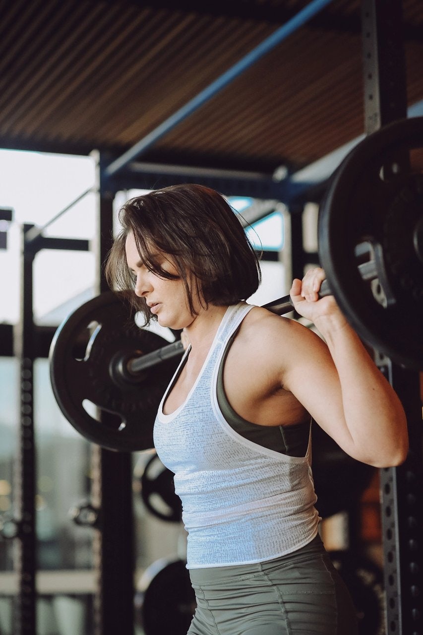 Young female using the squat rack in the fitness centre at Gunyama Park