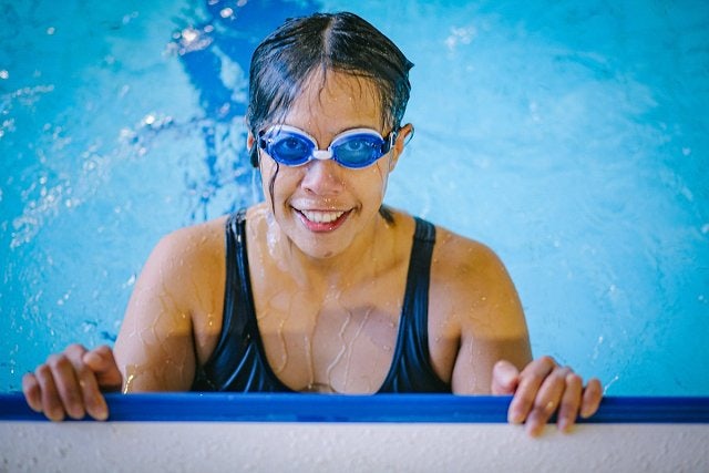 Swimmer smiling in the pool at Cook + Phillip Park Pool