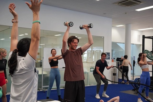 Participants smiling while using equipment in a group exercise class at Ian Thorpe Aquatic Centre 