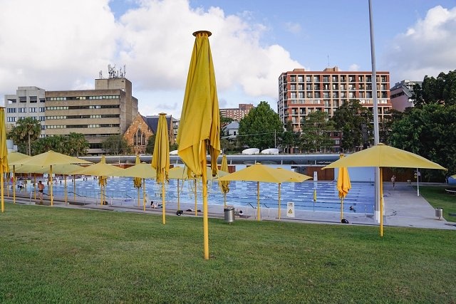 The pool side yellow umbrellas at Prince Alfred Park Pool